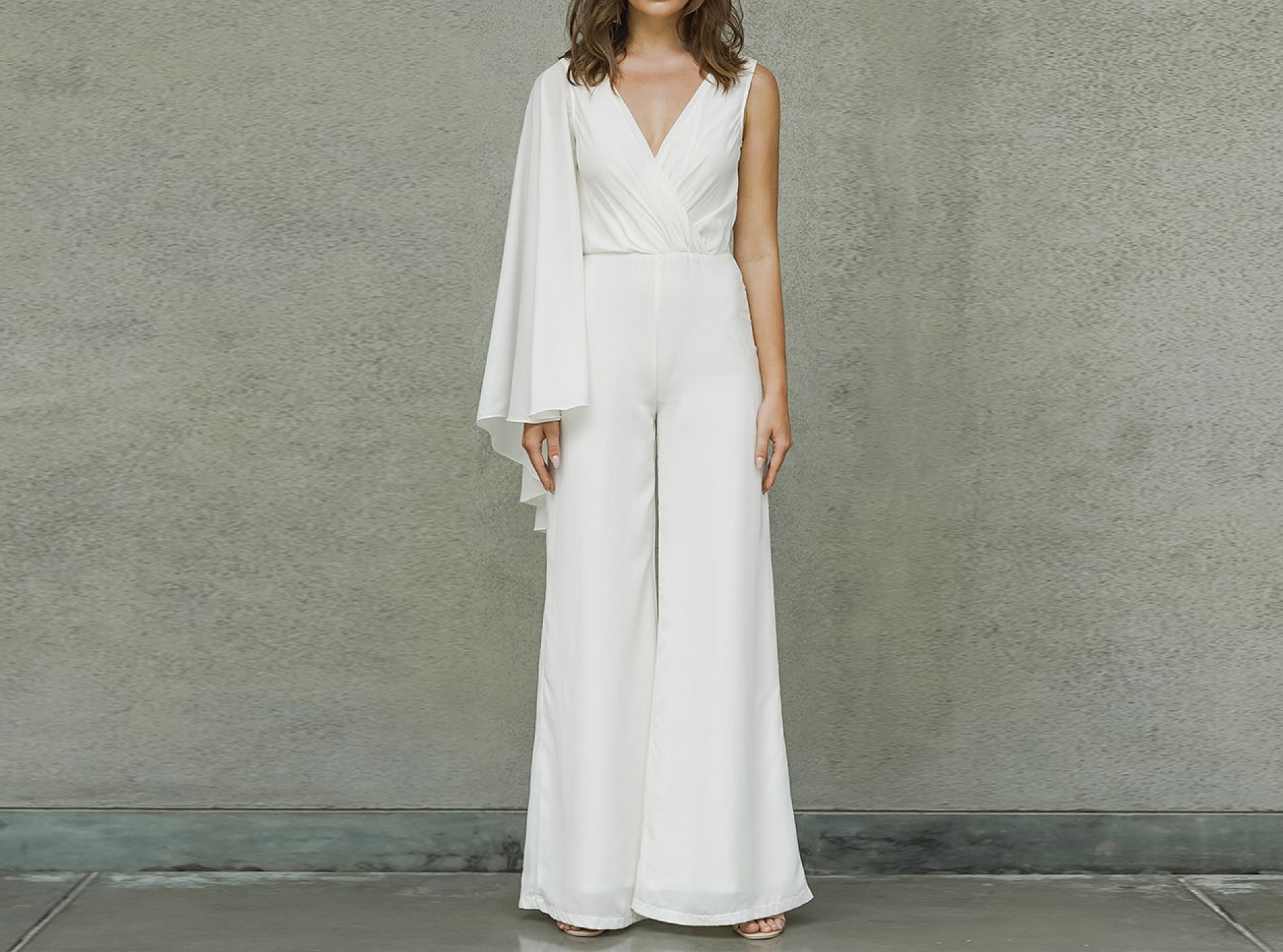 asymmetric caped plunge jumpsuit in ivory